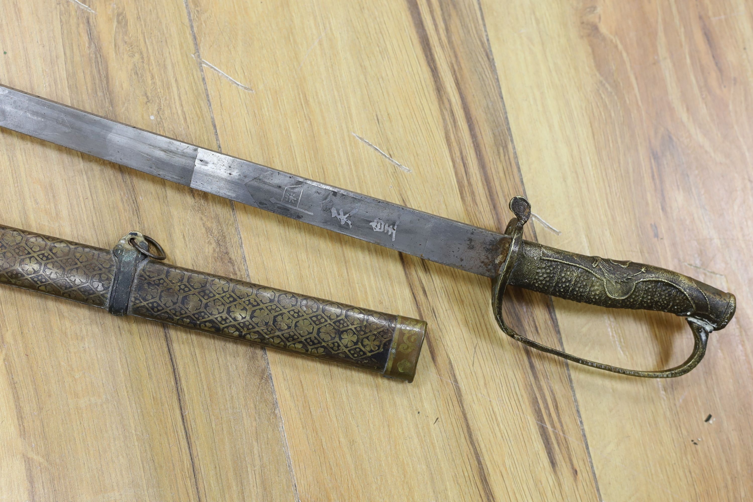 A Chinese sword, single edged blade 64cm long in etched brass scabbard
